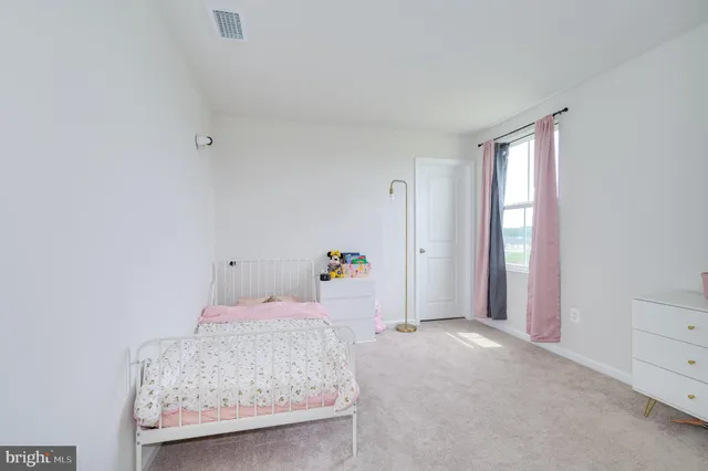 a bathroom with a toilet sink vanity and mirror