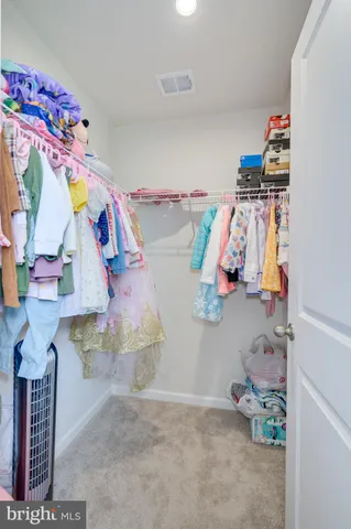 a spacious bedroom with a bed and a cabinets