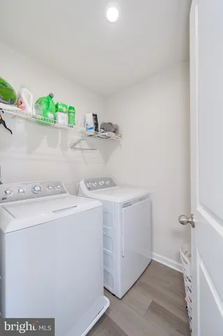 a view of a white house with a bench in patio