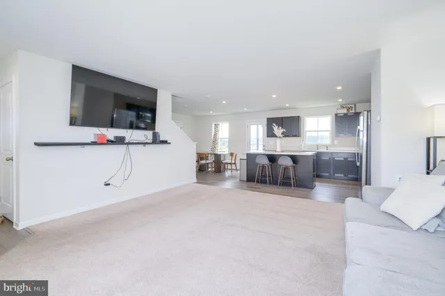 a large white room with a large window and flat screen tv