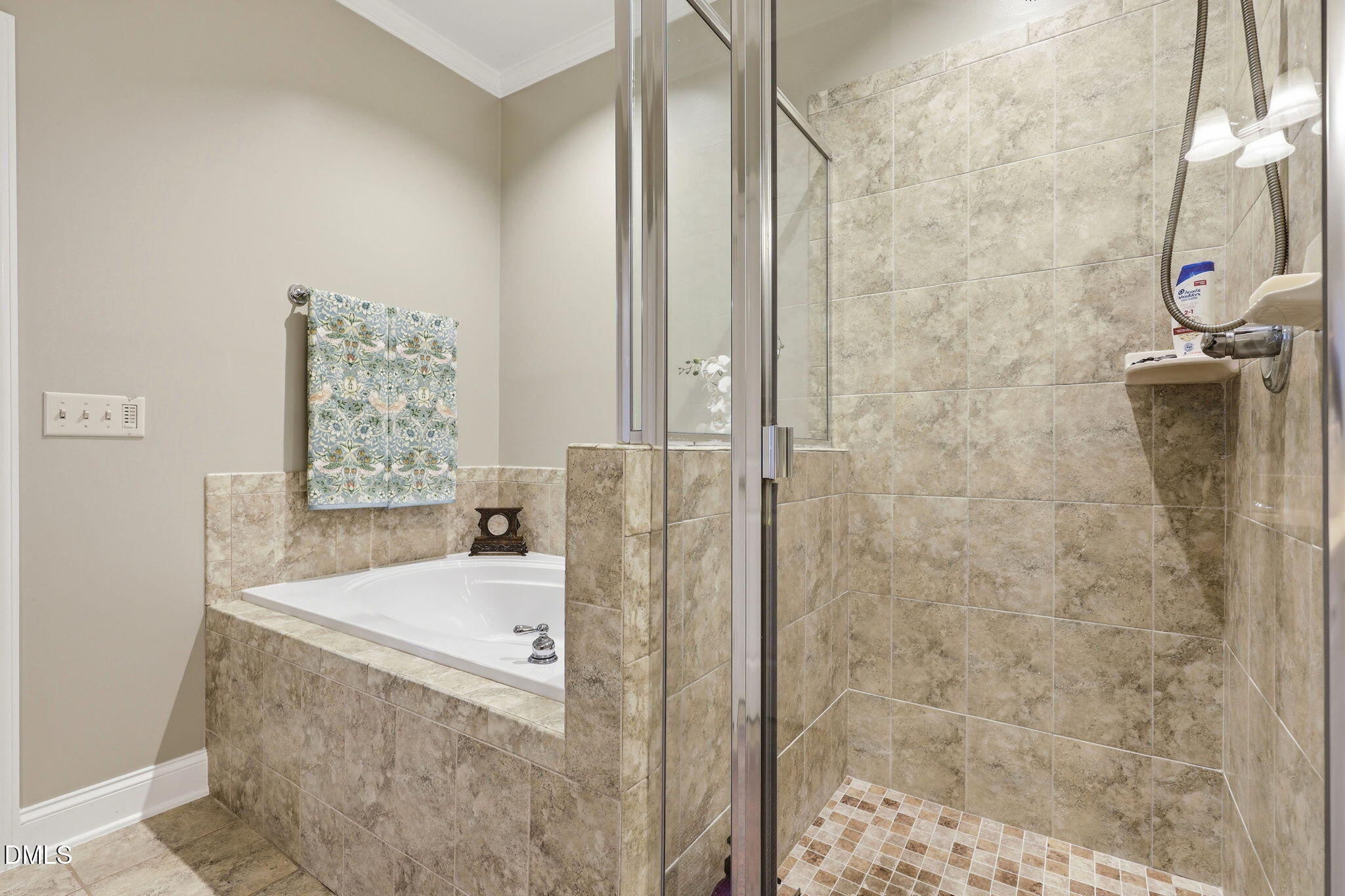 7040 Dayton Ridge Drive Apex, NC 27539 - Photo 23 of 38 a bathroom with a bathtub and shower