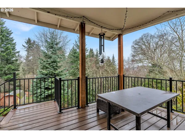 a view of a balcony with wooden floor and wooden fence