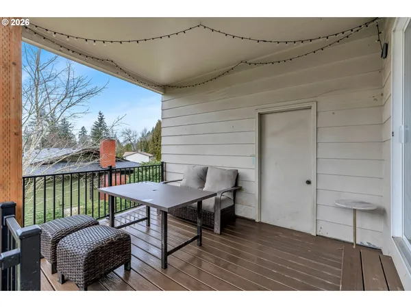a balcony with furniture and wooden floor