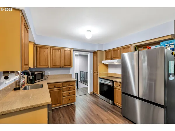 a kitchen with kitchen island a counter top space stainless steel appliances and cabinets