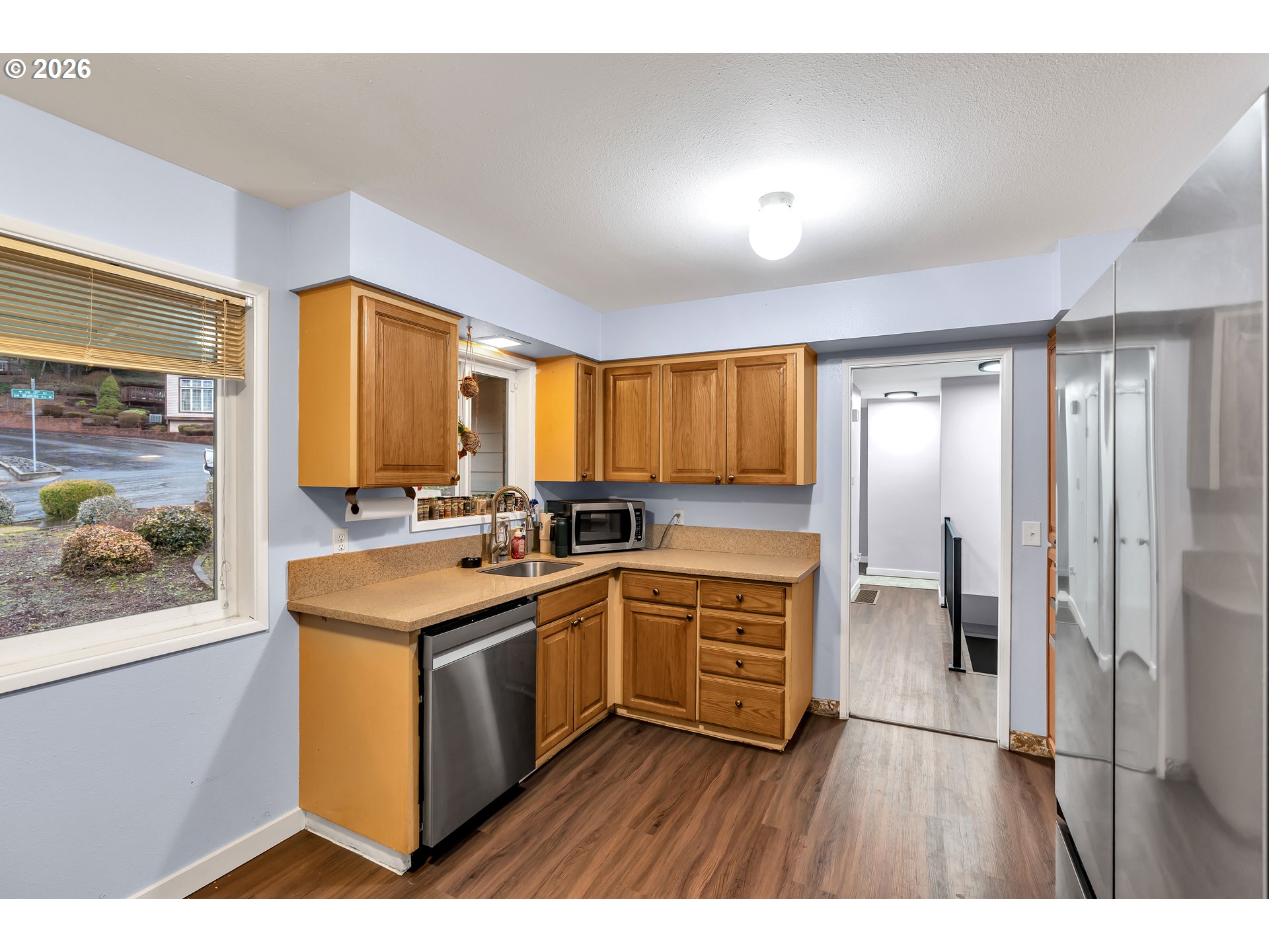 1320 Southwest 31st Street Gresham, OR 97080 - Photo 16 of 48 a kitchen with stainless steel appliances granite countertop a stove a sink and a refrigerator with wooden floor