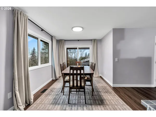 a dining room with furniture and wooden floor