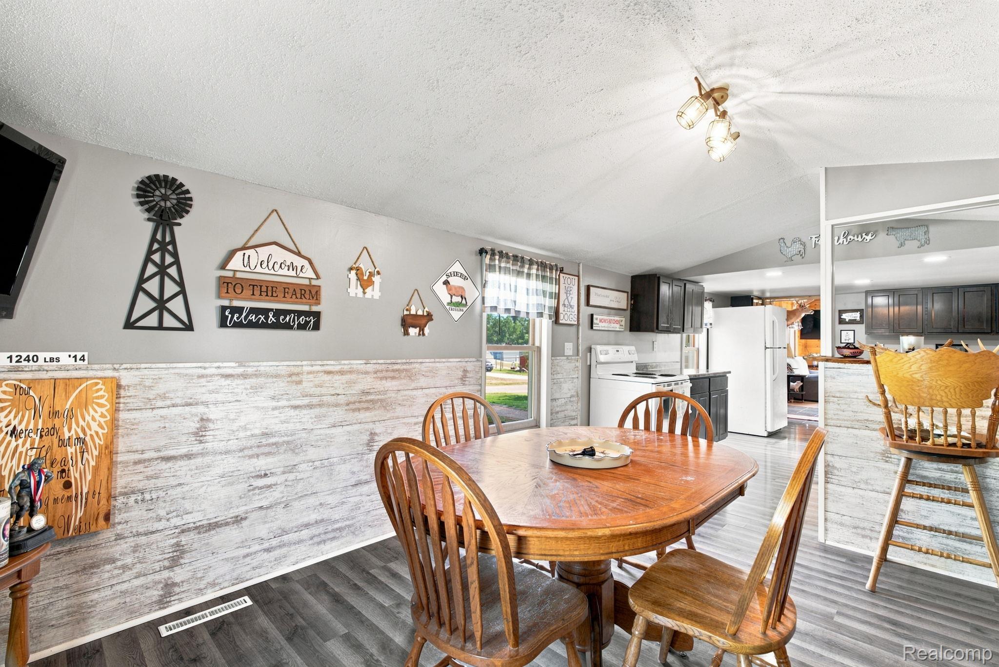4201 Galbraith Line Road Croswell, MI 48422 - Photo 18 of 39 Dining area featuring wood-finish flooring and wainscoting