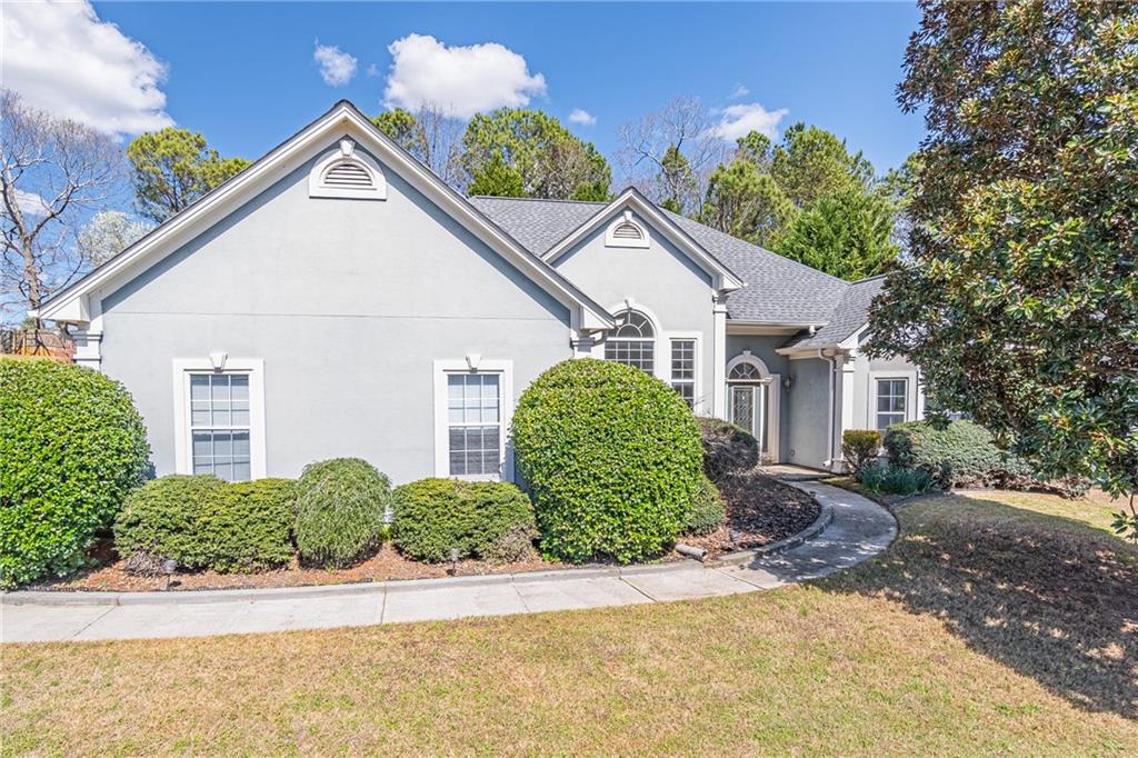 210 Ruby Forest Parkway Suwanee, GA 30024 - Photo 1 of 1 a view of a white house with a small yard plants and large tree