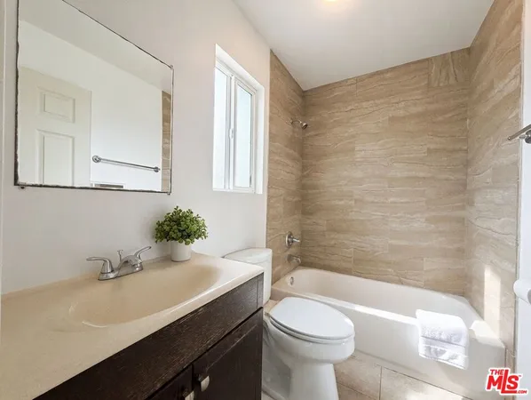a bathroom with a sink a toilet and bathtub