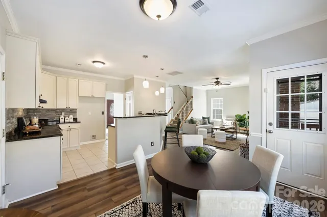 a dining room with furniture window and wooden floor