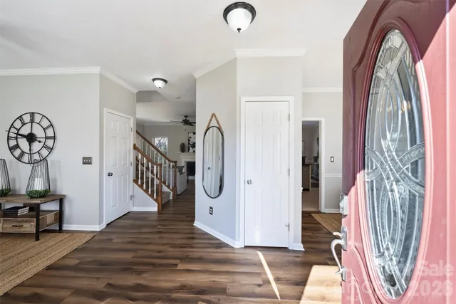 a living room with furniture a dining table and a chandelier