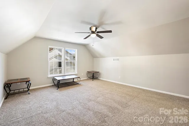 a view of a yard with wooden fence and trees