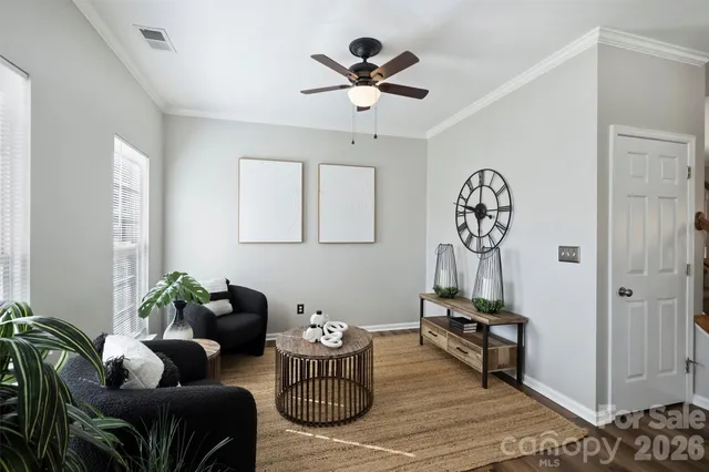 a dining room with furniture a chandelier and wooden floor