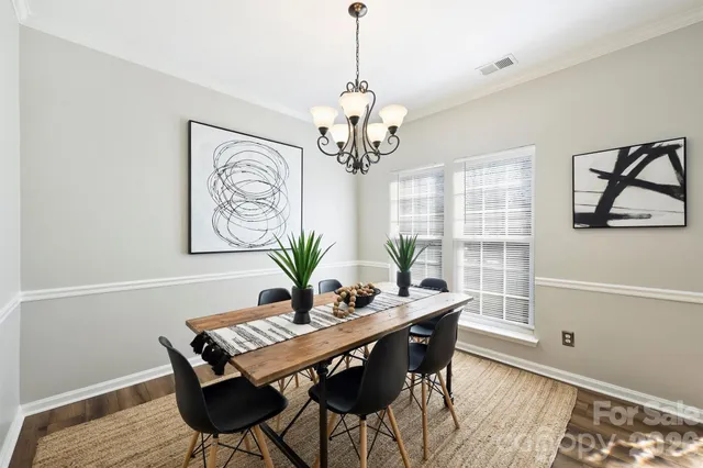 a dining room with furniture and a chandelier