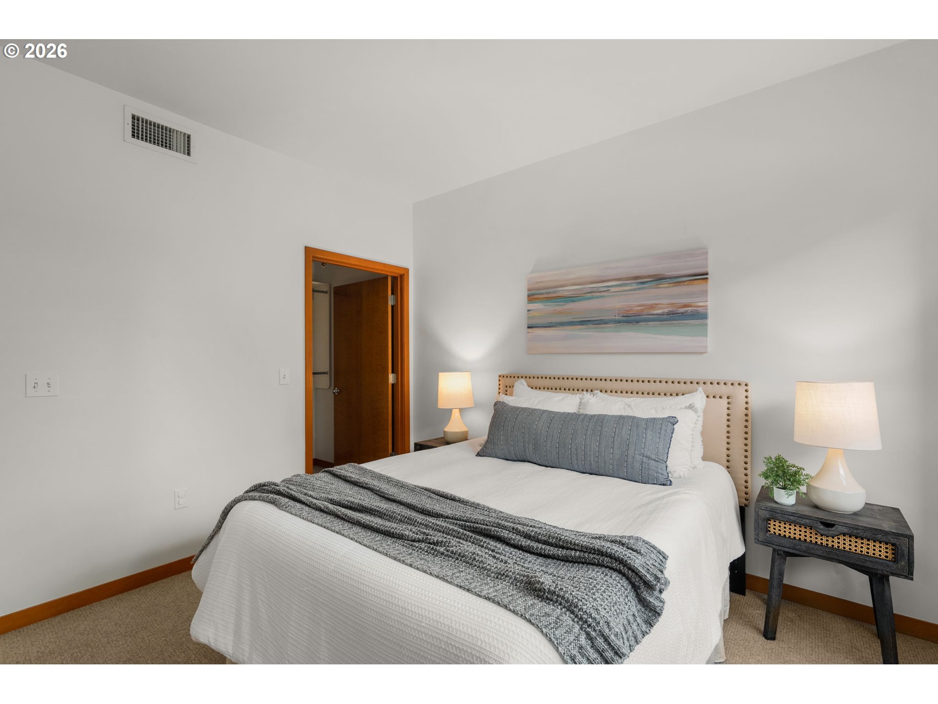 2350 Northwest Savier Street, Unit 224 Portland, OR 97210 - Photo 11 of 19 a bedroom with a bed and a lamp