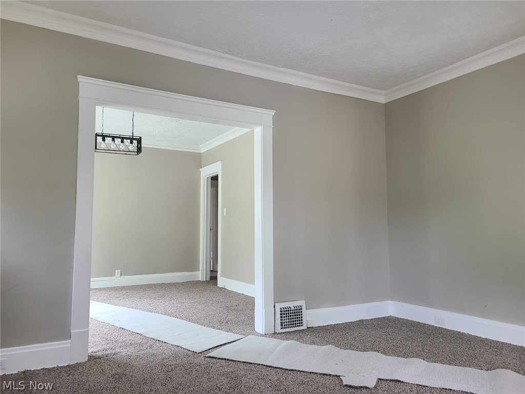 1830 Mannering Road Cleveland, OH 44112 - Photo 11 of 24 Carpeted spare room with ornamental molding