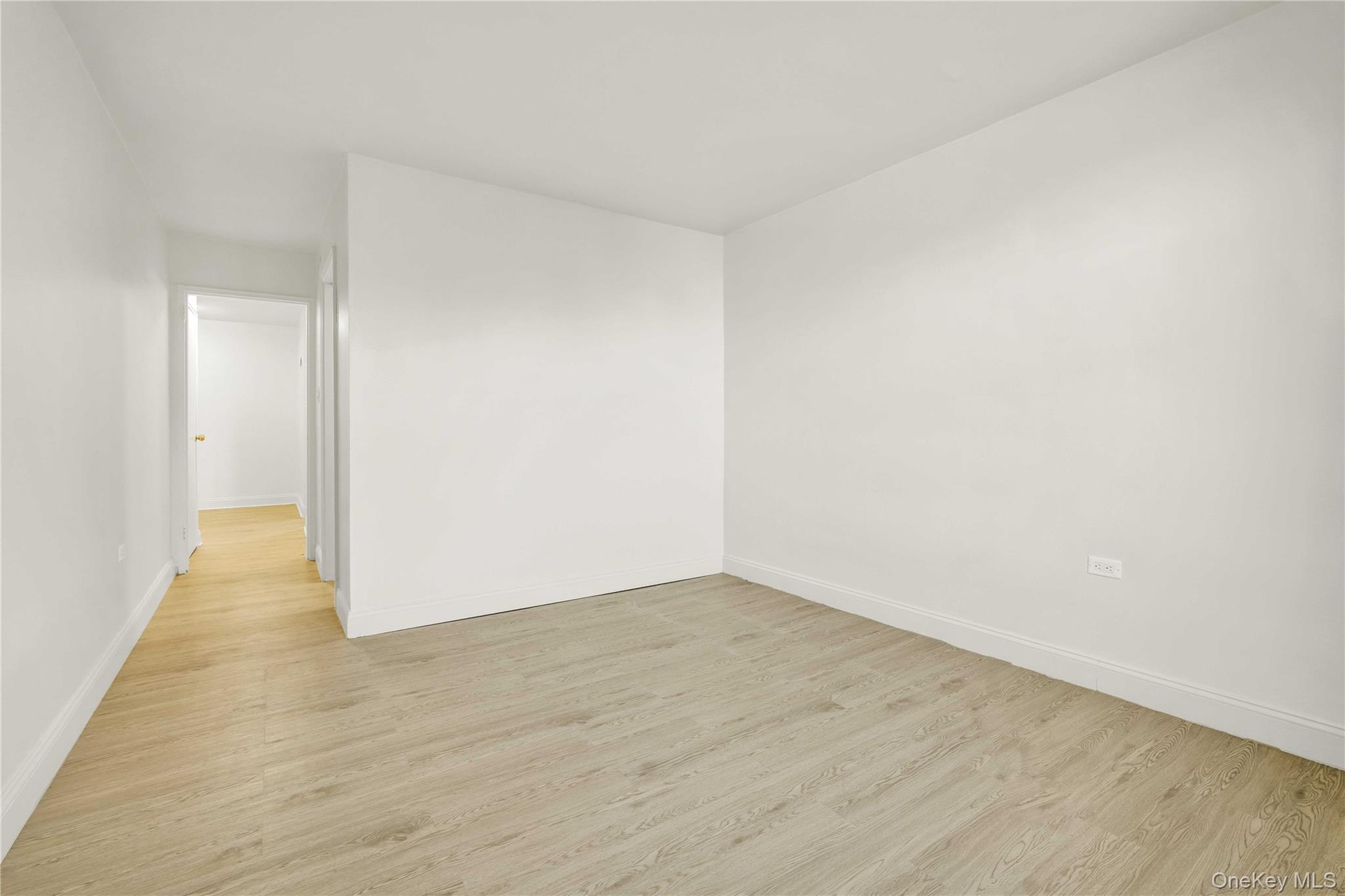 34-20 Parsons Boulevard, Unit 4W Queens, NY 11354 - Photo 11 of 17 a view of an empty room with wooden floor