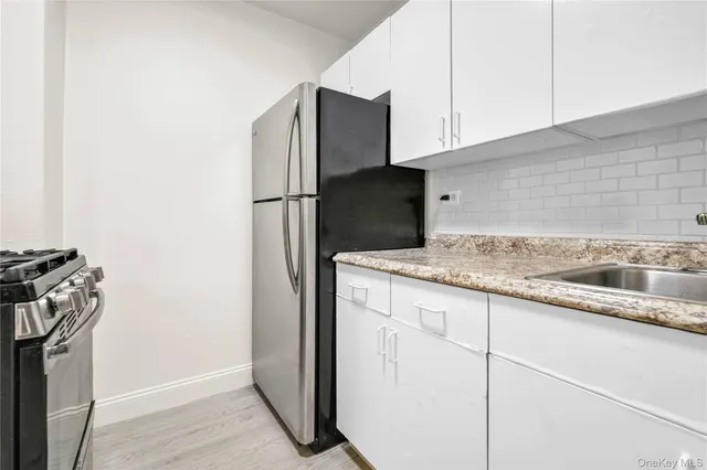 a bathroom with a bathtub a shower a sink and vanity