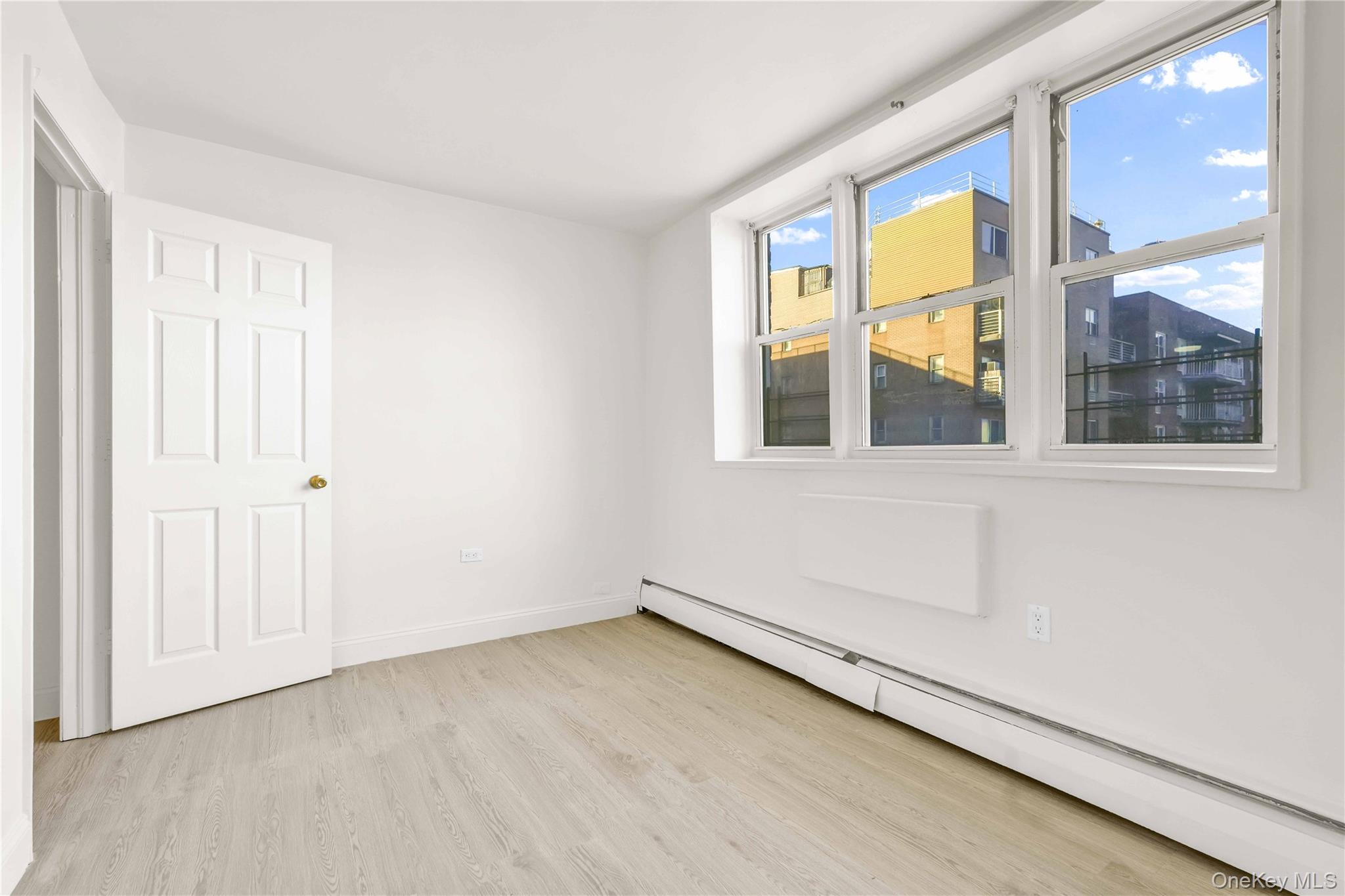34-20 Parsons Boulevard, Unit 4W Queens, NY 11354 - Photo 5 of 17 an empty room with windows