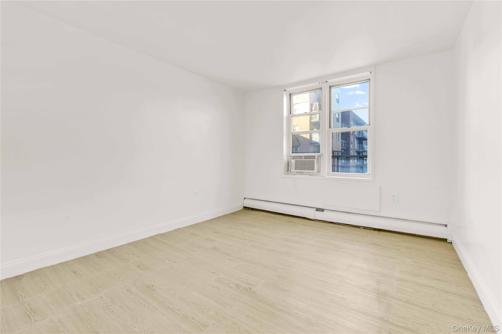 34-20 Parsons Boulevard, Unit 4W Queens, NY 11354 - Photo 8 of 17 an empty room with a window