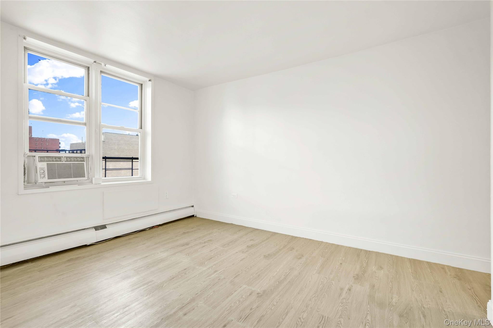 34-20 Parsons Boulevard, Unit 4W Queens, NY 11354 - Photo 9 of 17 an empty room with a window