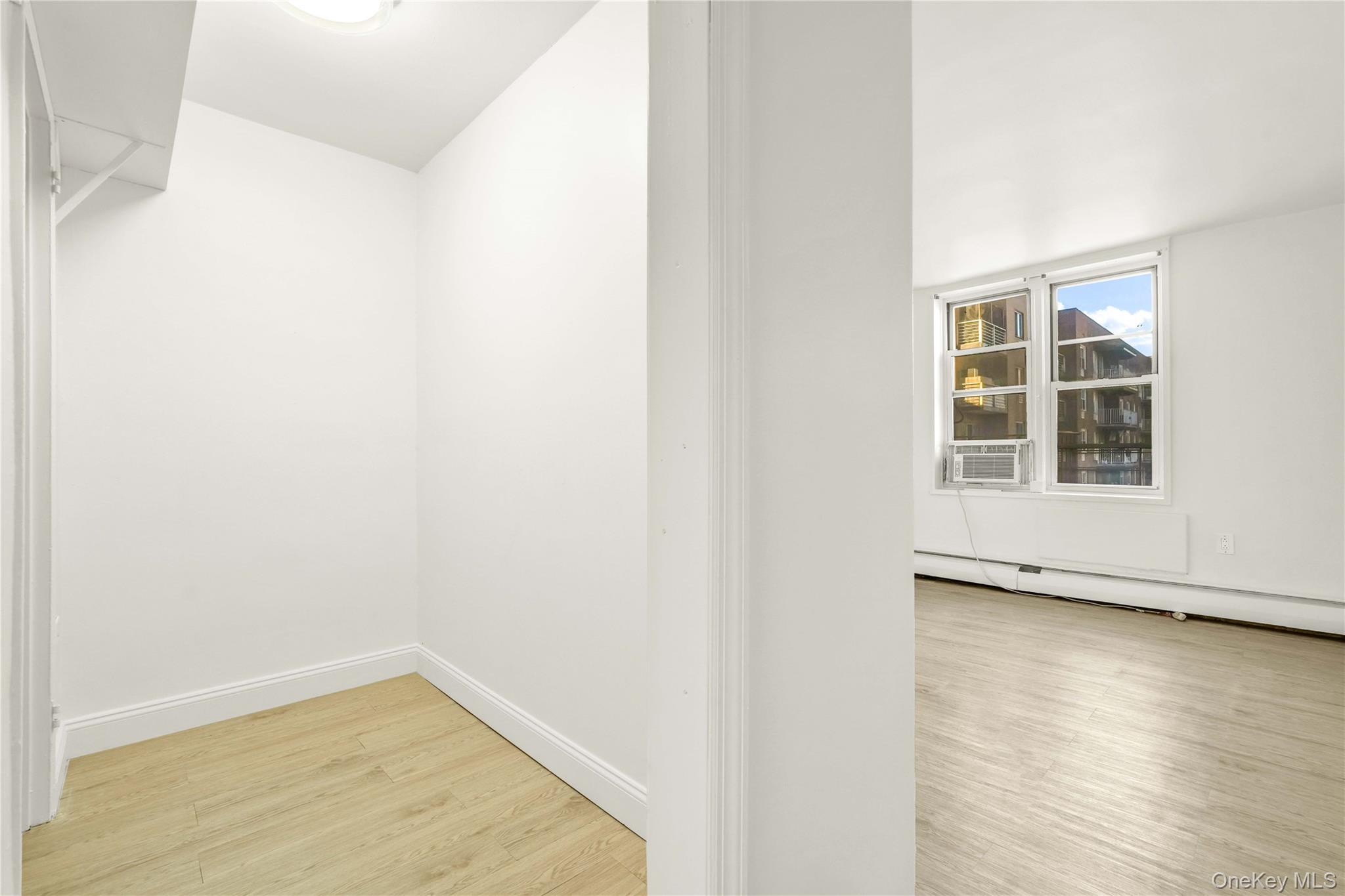 34-20 Parsons Boulevard, Unit 4W Queens, NY 11354 - Photo 10 of 17 a view of empty room with wooden floor and fan