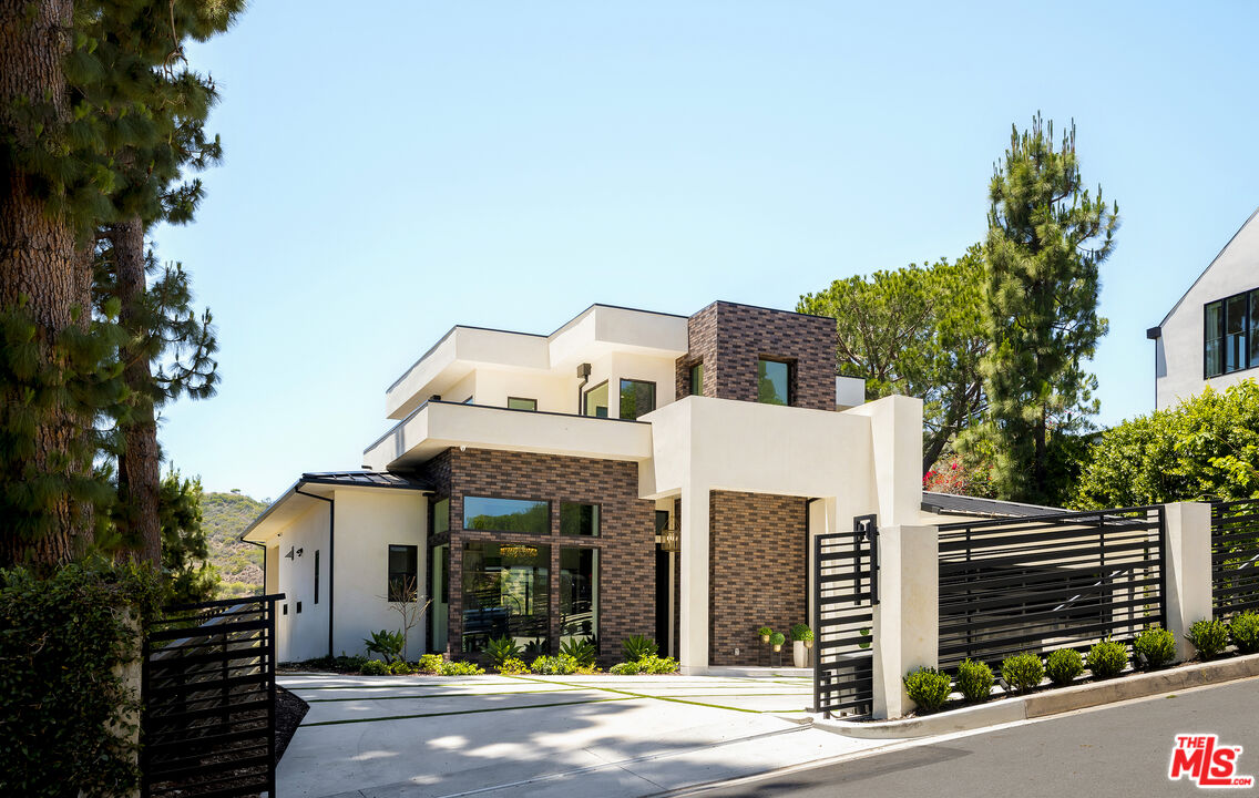 1367 Casiano Road Los Angeles, CA 90049 - Photo 2 of 26 a front view of a house with a tree