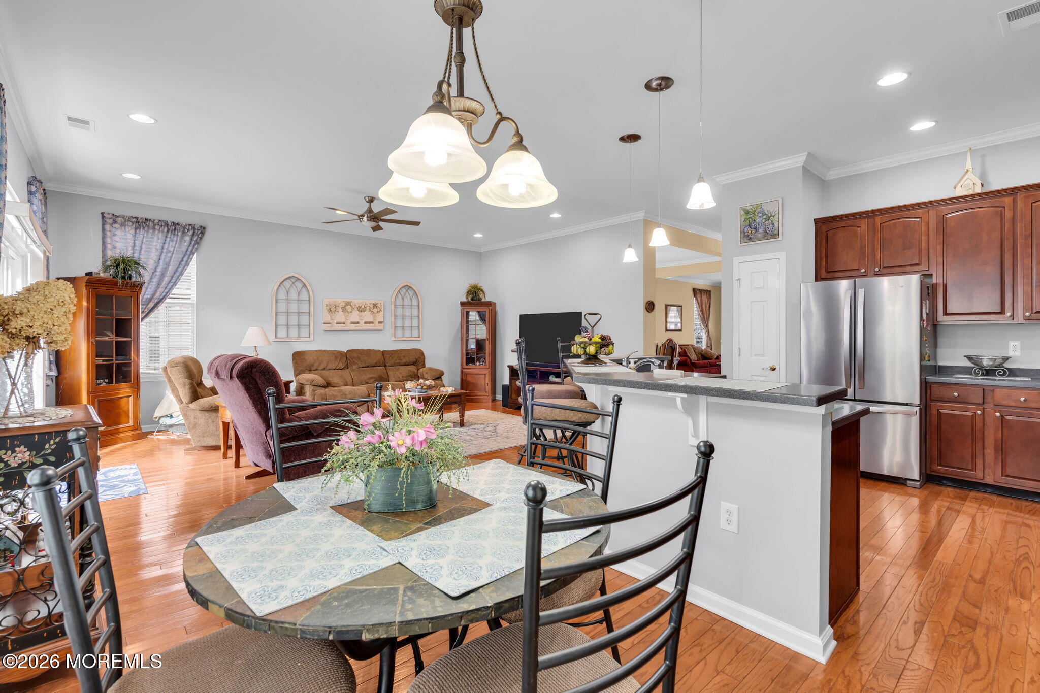 56 Pond View Circle Barnegat, NJ 08005 - Photo 12 of 32 a view of a dining room with furniture a chandelier and wooden floor