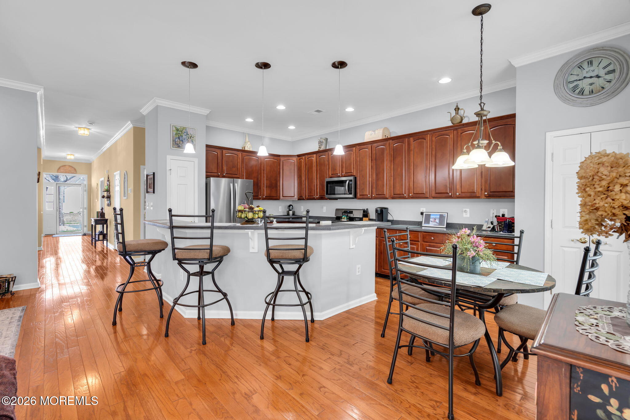 56 Pond View Circle Barnegat, NJ 08005 - Photo 9 of 32 a kitchen with stainless steel appliances kitchen island granite countertop a stove a refrigerator a oven a sink with island chairs and wooden floor