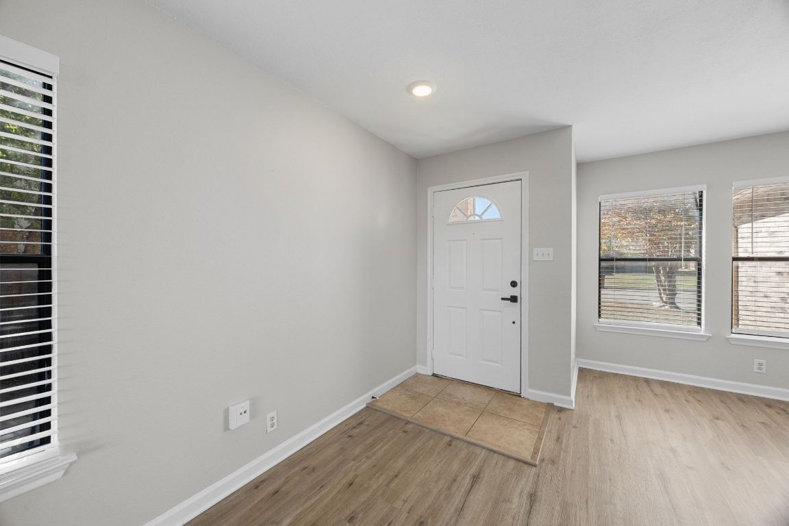 1326 Lakeside Loop Round Rock, TX 78665 - Photo 2 of 29 an empty room with wooden floor and windows