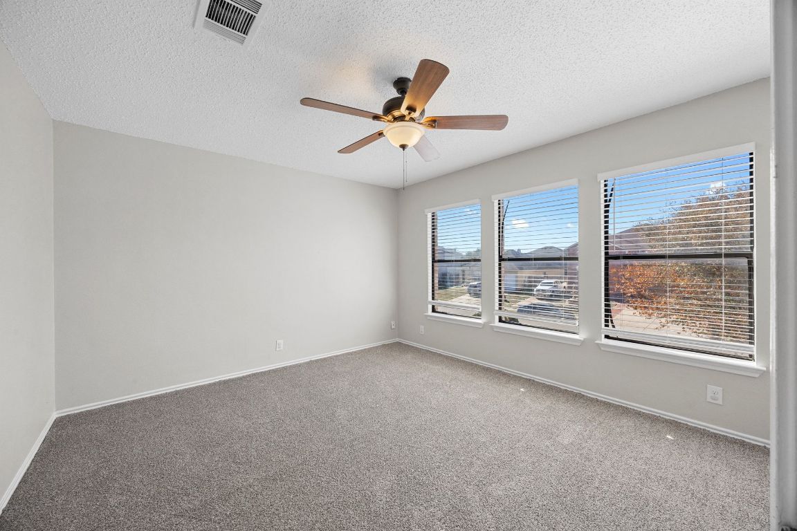 1326 Lakeside Loop Round Rock, TX 78665 - Photo 21 of 29 an empty room with windows and fan