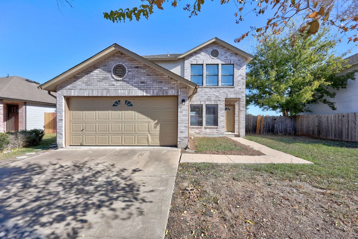 1326 Lakeside Loop Round Rock, TX 78665 - Photo 29 of 29 a front view of a house with a yard and garage