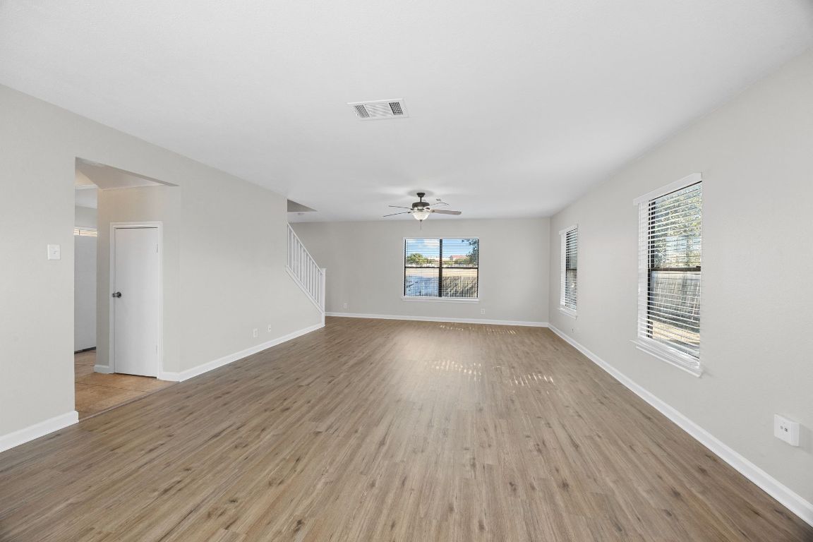1326 Lakeside Loop Round Rock, TX 78665 - Photo 3 of 29 an empty room with wooden floor and windows