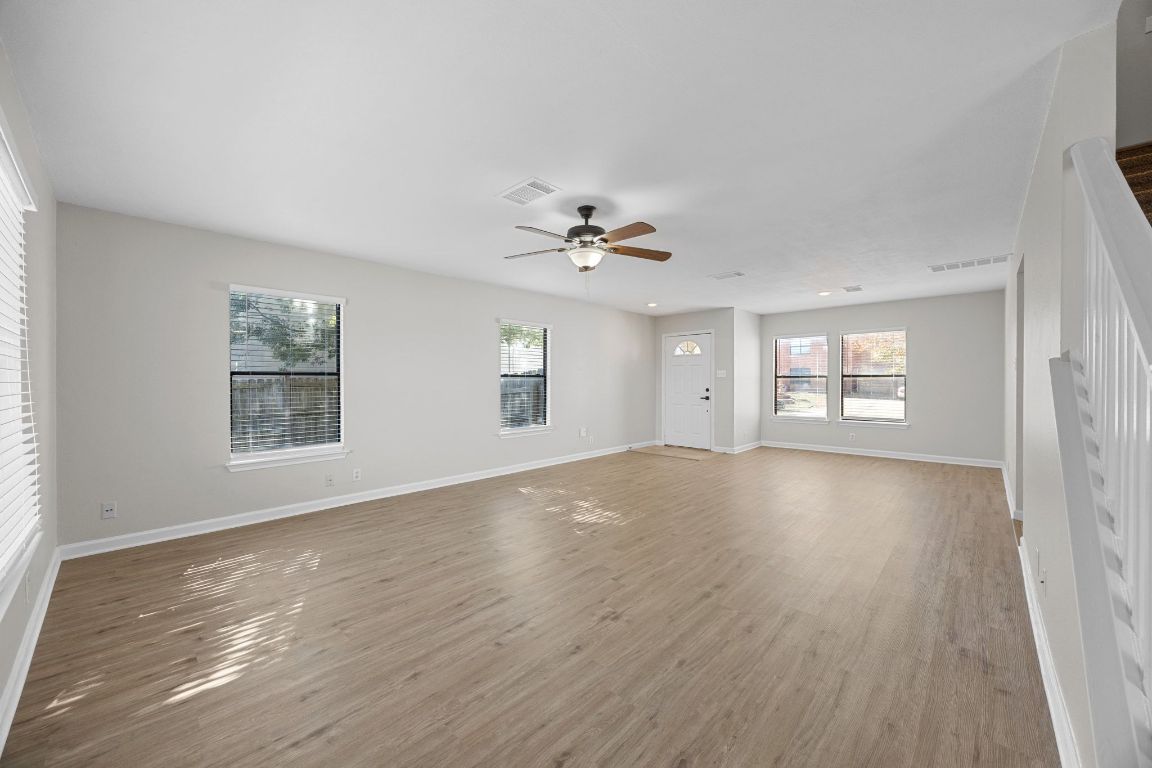 1326 Lakeside Loop Round Rock, TX 78665 - Photo 5 of 29 a view of an empty room with a window and wooden floor