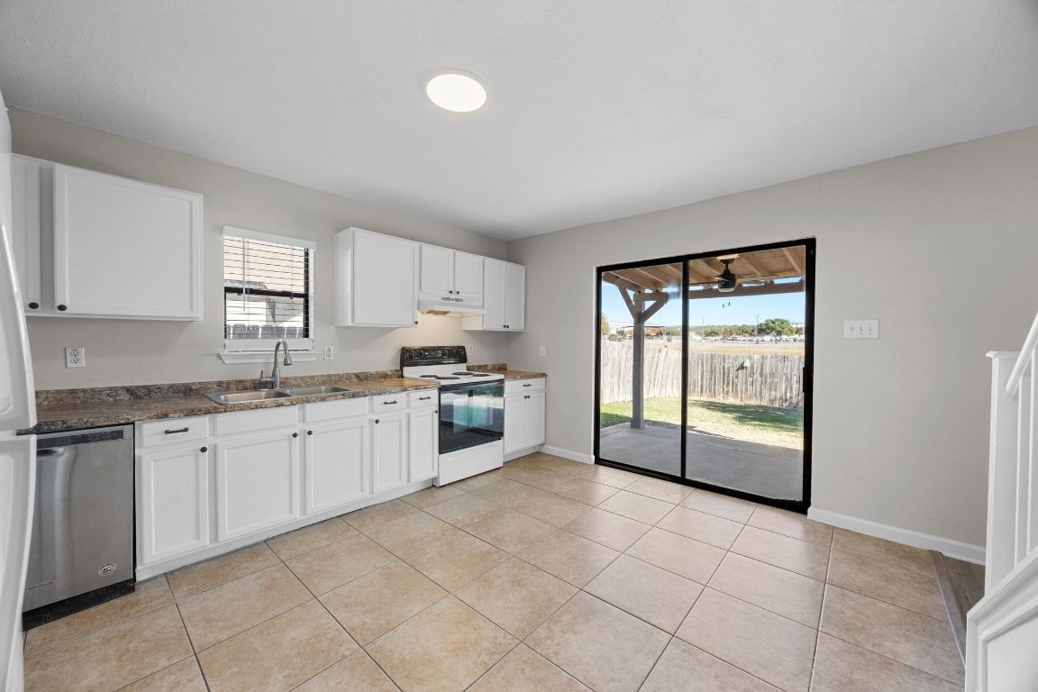 1326 Lakeside Loop Round Rock, TX 78665 - Photo 9 of 29 a large kitchen with granite countertop a stove a sink and a granite counter tops