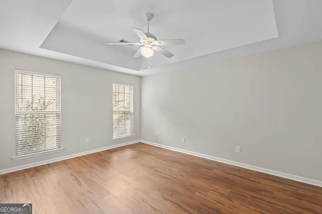 a view of an empty room with wooden floor