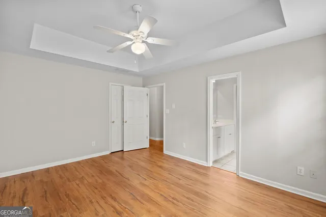 a bathroom with a granite countertop sink and a bathtub