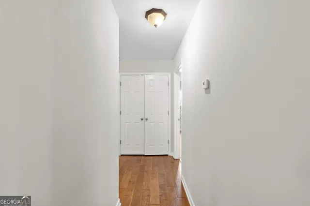 a view of an empty room with wooden floor