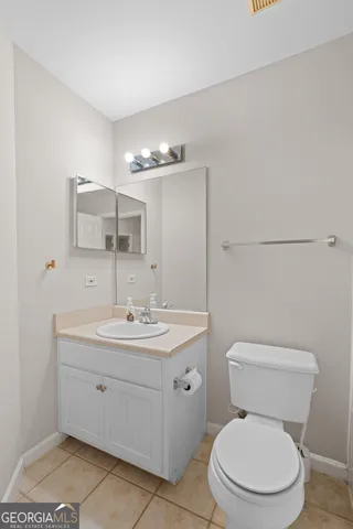 an empty room with chandelier fan and ceiling fan