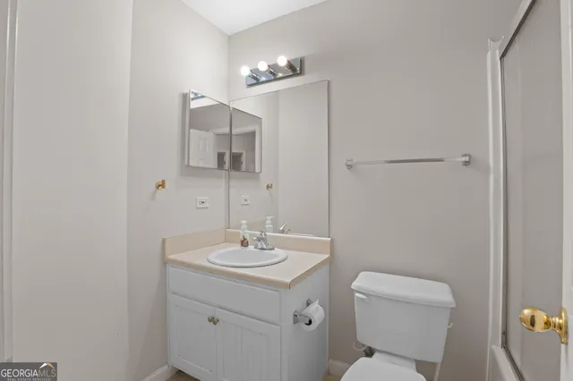 an empty room with a chandelier fan and windows