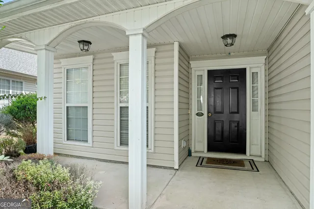 front view of a brick house with a door and a window