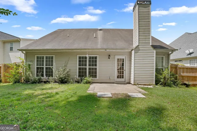 an aerial view of a house with swimming pool patio and outdoor seating