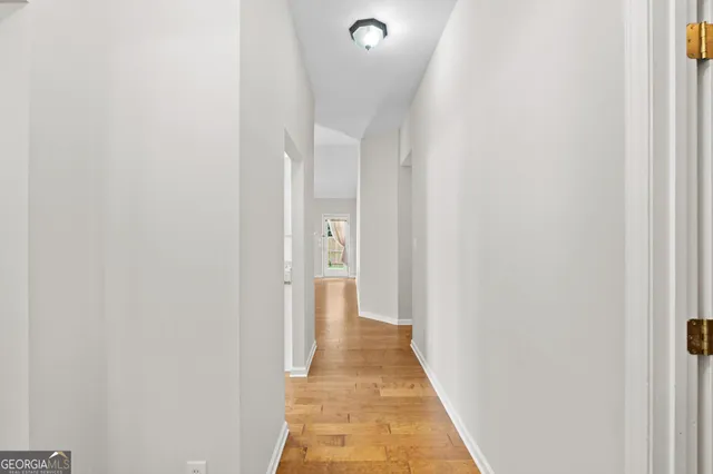 a view of a hallway with wooden floor