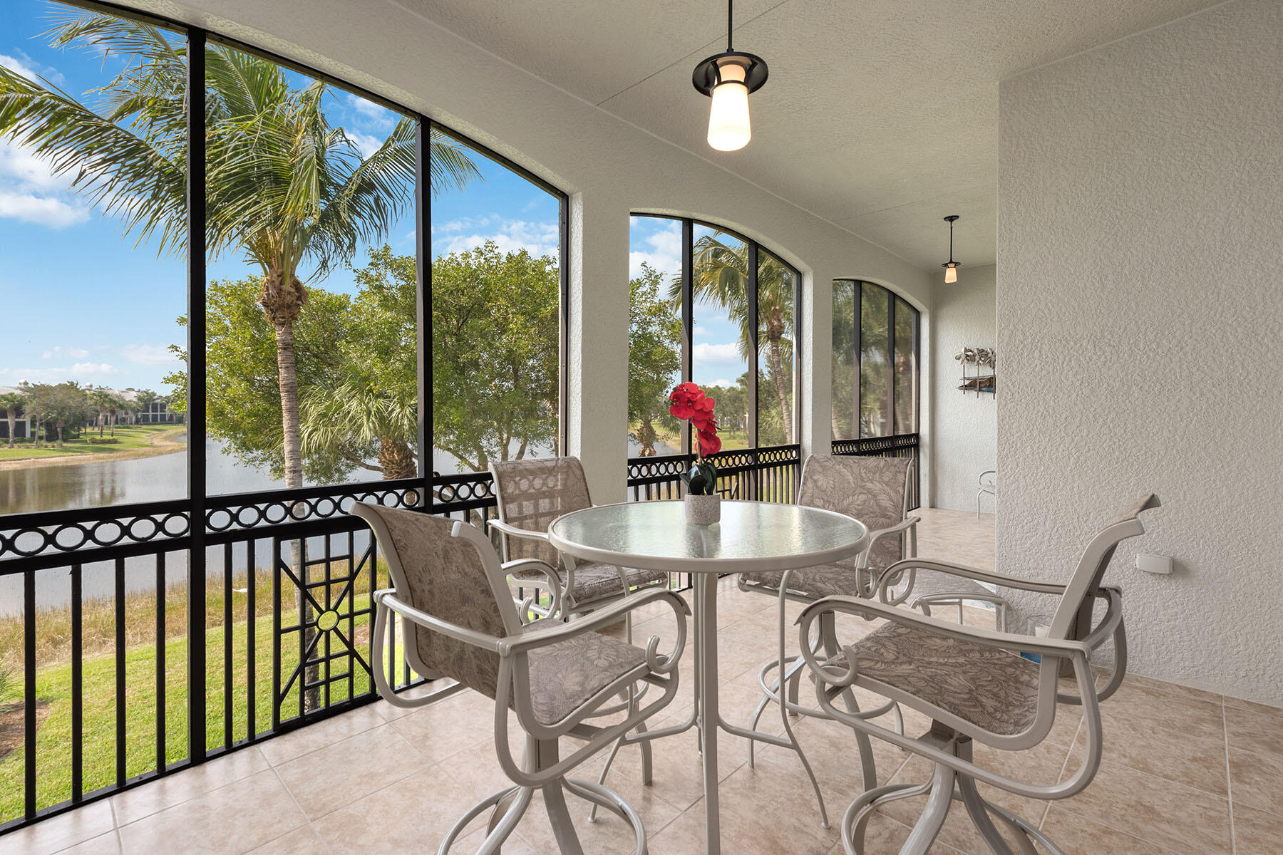 9263 Museo Circle, Unit 202 Naples, FL 34114 - Photo 1 of 45 a view of a dining room with furniture large windows and wooden floor