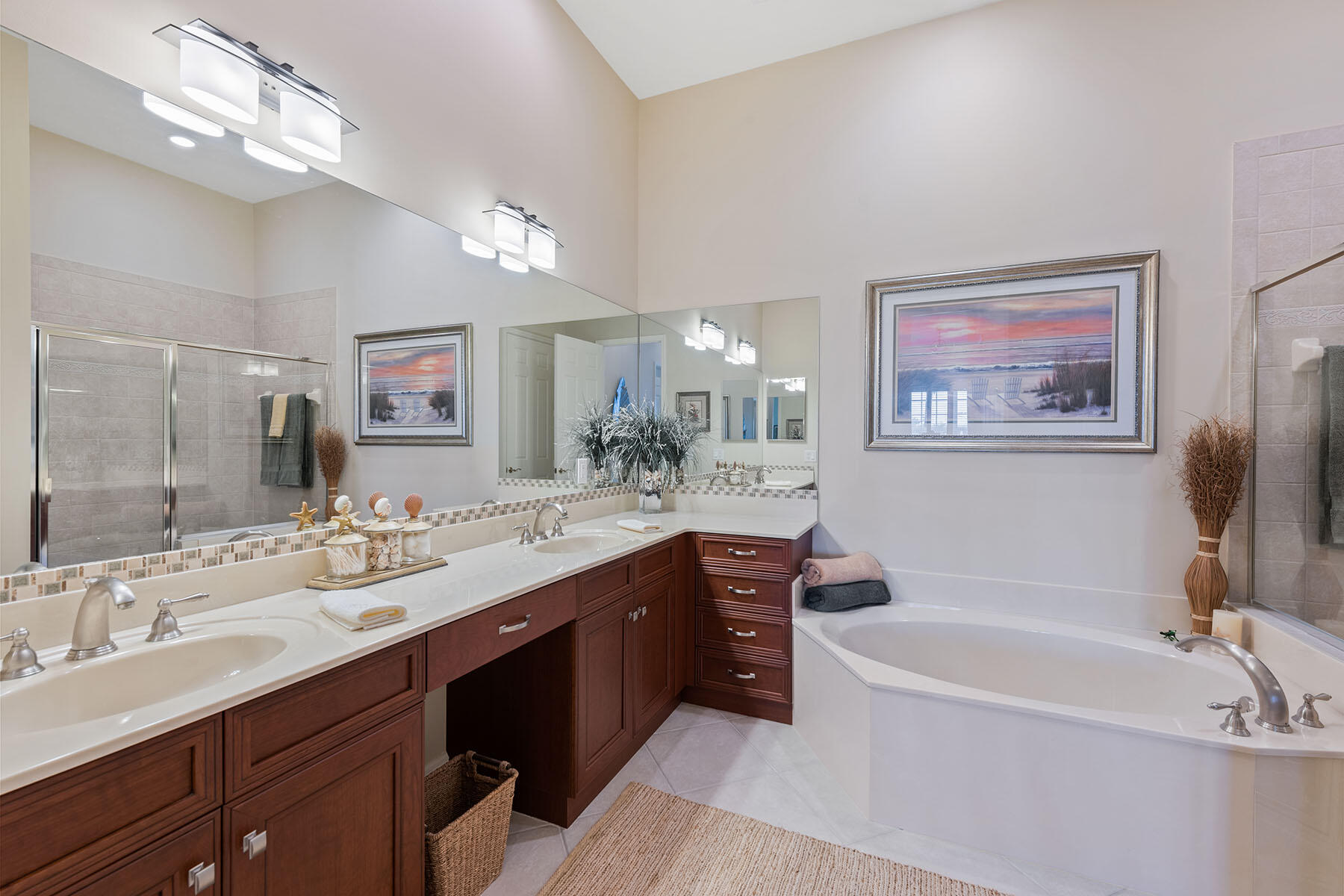 9263 Museo Circle, Unit 202 Naples, FL 34114 - Photo 11 of 45 a bathroom with a tub a double vanity sink and a mirror