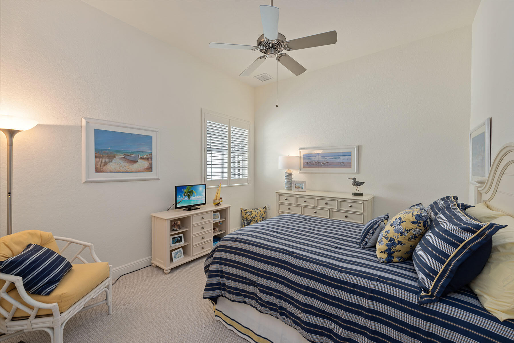 9263 Museo Circle, Unit 202 Naples, FL 34114 - Photo 13 of 45 a bedroom with a bed and a chandelier