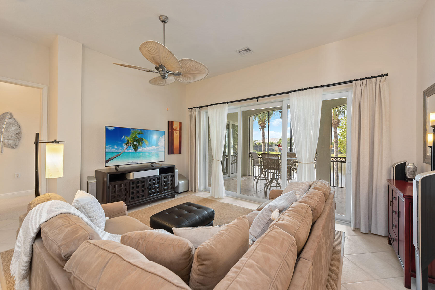 9263 Museo Circle, Unit 202 Naples, FL 34114 - Photo 3 of 45 a living room with furniture a fireplace and a flat screen tv