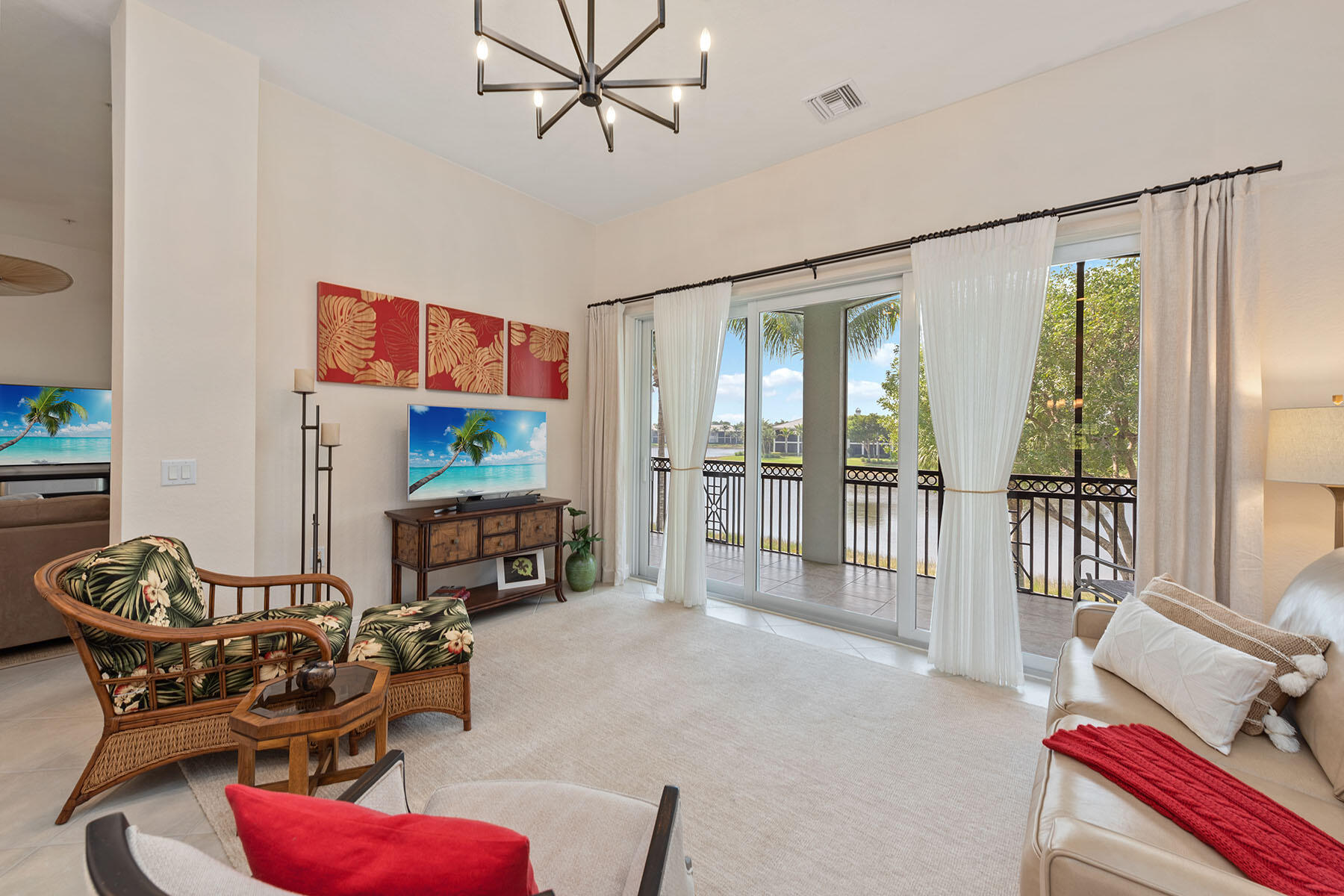 9263 Museo Circle, Unit 202 Naples, FL 34114 - Photo 4 of 45 a living room with furniture a flat screen tv and a large window