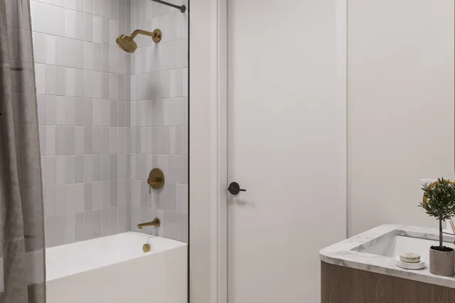 a bathroom with a granite countertop bathtub and a shower