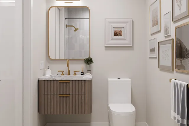 a bathroom with a toilet a sink a mirror a and vanity